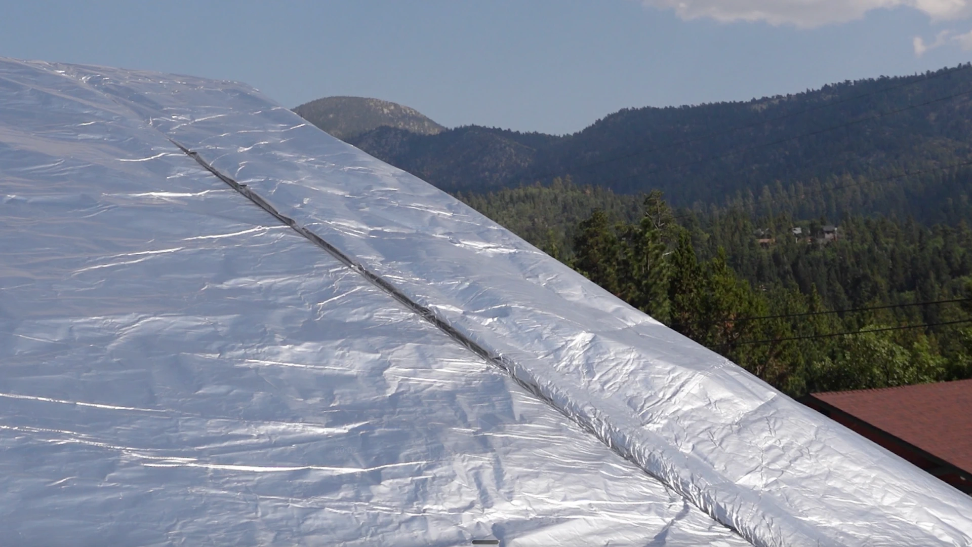FireFoil roof protection with mountain forest backdrop